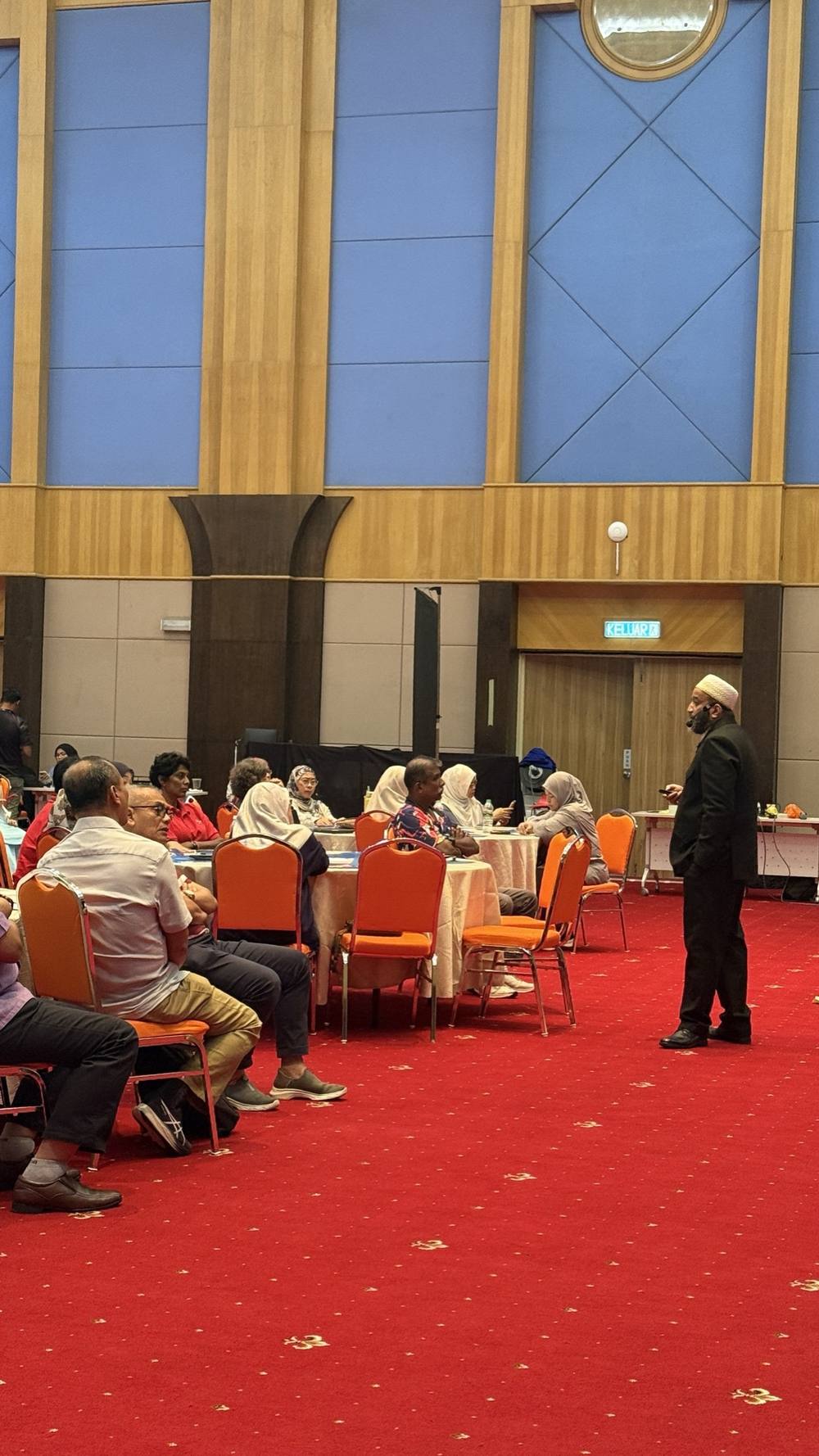 Dr. Onn addressing an audience in a ballroom