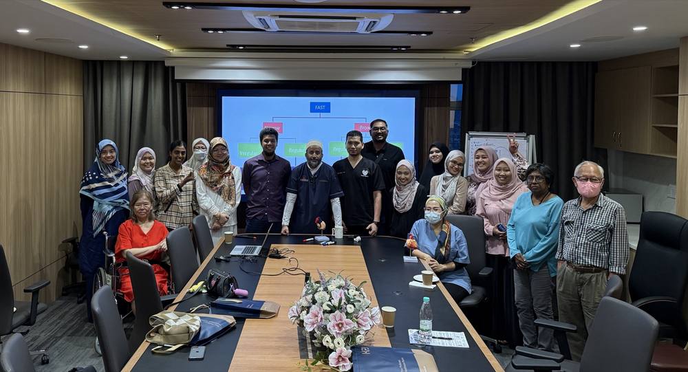 Dr. Onn with participants at a boardroom session