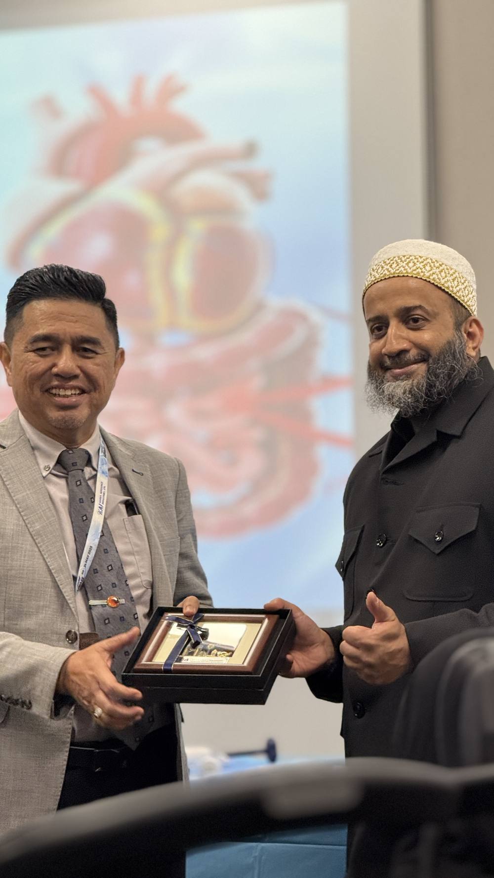 Dr. Onn receiving a token of appreciation at a conference
