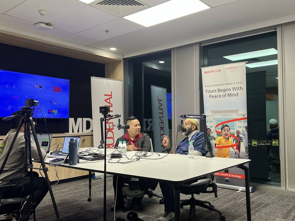 Dr. Onn recording a podcast in the studio