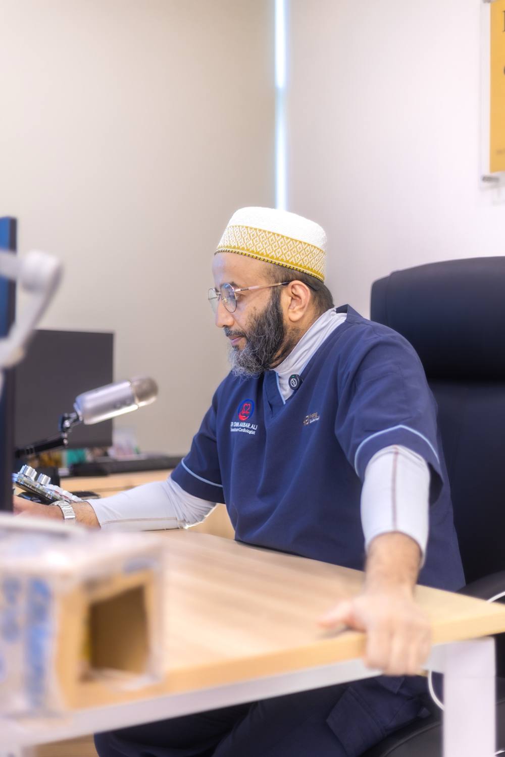 Dr. Onn recording a video message at his desk
